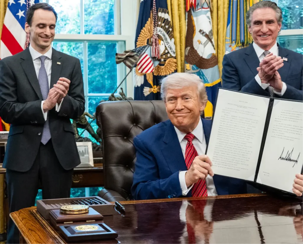 A photo of Donald Trump signing an Executive Order